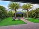 Lush backyard featuring a gazebo, palm trees and artificial grass at 2227 Blue Salvia St, Clermont, FL 34711