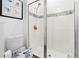Modern bathroom showcasing a glass-enclosed shower with decorative tile and Stitch-themed toilet seat at 2227 Blue Salvia St, Clermont, FL 34711