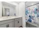 Charming bathroom featuring a double sink vanity and playful Stitch-themed shower curtain at 2227 Blue Salvia St, Clermont, FL 34711