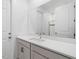 Well-lit bathroom with modern vanity, sleek countertop, and a large mirror reflecting the shower at 2227 Blue Salvia St, Clermont, FL 34711