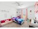 Charming bedroom with princess-themed decor, soft lighting, and cozy carpet at 2227 Blue Salvia St, Clermont, FL 34711