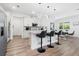 Charming kitchen featuring stainless steel appliances, white cabinets, and a cozy breakfast bar at 2227 Blue Salvia St, Clermont, FL 34711