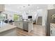 Open-concept kitchen featuring an island with pendant lighting, stainless steel appliances, and modern finishes at 2227 Blue Salvia St, Clermont, FL 34711