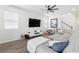 Bright living room features a large sectional sofa, hardwood floors, and modern entertainment center at 2227 Blue Salvia St, Clermont, FL 34711