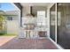 Outdoor kitchen featuring a built-in grill, brick flooring, and stainless steel storage at 2227 Blue Salvia St, Clermont, FL 34711