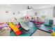Bright playroom with a white couch, lots of toys and a large ceiling fan at 2227 Blue Salvia St, Clermont, FL 34711