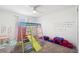 Bright playroom with climbing structure, playmat, and alphabet wall decor at 2227 Blue Salvia St, Clermont, FL 34711
