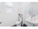 Stylish powder room featuring a pedestal sink, modern fixtures, and a storage cabinet at 2227 Blue Salvia St, Clermont, FL 34711