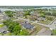 An aerial view of the home with lush greenery, and a glimpse of a lake in the distance at 2311 Alton Rd, Deltona, FL 32738