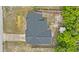 Aerial view of a home with a dark gray roof and an adjacent shed surrounded by lush greenery at 2311 Alton Rd, Deltona, FL 32738