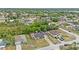 An aerial shot showcasing a single-Gathering home in a residential neighborhood with lush trees and well-kept yards at 2311 Alton Rd, Deltona, FL 32738