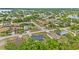 An aerial view of the home nestled in a community with mature trees and a glimpse of a lake in the distance at 2311 Alton Rd, Deltona, FL 32738