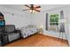 Bright bedroom with ceiling fan, large window, and hardwood floors at 2311 Alton Rd, Deltona, FL 32738