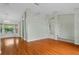 Open dining area featuring wood floors, a chandelier, and large windows for natural light at 2311 Alton Rd, Deltona, FL 32738