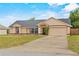 Lovely single-story home boasting a spacious driveway and attached two-car garage at 2311 Alton Rd, Deltona, FL 32738