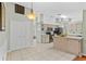 Open layout kitchen area has stainless steel appliances and white tile flooring throughout at 2311 Alton Rd, Deltona, FL 32738