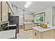 The kitchen is equipped with stainless steel appliances, stone countertops and a bright window at 2311 Alton Rd, Deltona, FL 32738