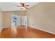 The bright main bedroom has wood flooring and dual closets leading to an en-suite bathroom at 2311 Alton Rd, Deltona, FL 32738