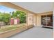 Open, covered patio with concrete flooring and an enclosed backyard with a shed at 2311 Alton Rd, Deltona, FL 32738