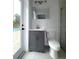 Updated bathroom with gray vanity, modern fixtures, and a door to the pool area at 2318 Mohawk Trl, Maitland, FL 32751