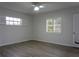 Comfortable bedroom with ceiling fan, windows with shutters, and wood-look floors at 2318 Mohawk Trl, Maitland, FL 32751