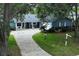 Charming single-story blue home with a brick driveway and well-maintained landscaping at 2318 Mohawk Trl, Maitland, FL 32751