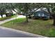 Charming blue home with mature trees, lush landscaping, and a well-maintained front yard at 2318 Mohawk Trl, Maitland, FL 32751