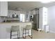 Bright kitchen featuring white cabinetry, a breakfast bar, and stainless steel appliances at 2318 Mohawk Trl, Maitland, FL 32751