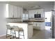 Modern kitchen with white cabinets, granite countertops, and a breakfast bar with seating at 2318 Mohawk Trl, Maitland, FL 32751