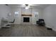 Spacious living room featuring a brick fireplace, new flooring, and natural light at 2318 Mohawk Trl, Maitland, FL 32751