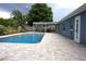 Sparkling swimming pool surrounded by brick pavers and lush landscaping, ideal for summer fun at 2318 Mohawk Trl, Maitland, FL 32751