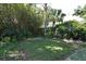 Lush backyard with tropical landscaping, offering a private and serene outdoor space at 2810 Nancy St, Orlando, FL 32806
