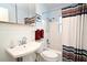 Bright bathroom featuring a shower and tub combo with a pedestal sink at 2810 Nancy St, Orlando, FL 32806