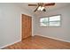 Cozy bedroom featuring hardwood floors, a ceiling fan, and a window for natural light at 2810 Nancy St, Orlando, FL 32806