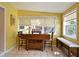 Sunny dining area with large windows, a wooden table, and additional seating area at 2810 Nancy St, Orlando, FL 32806