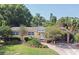 Charming single story home with beautiful landscaping, brick driveway and walkway on a sunny day at 2810 Nancy St, Orlando, FL 32806