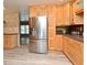 Kitchen featuring stainless steel refrigerator, light wood cabinets, and view into other living spaces at 2810 Nancy St, Orlando, FL 32806