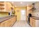 Updated kitchen with stainless steel appliances, light wood cabinets and modern tile backsplash at 2810 Nancy St, Orlando, FL 32806