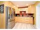 Updated kitchen featuring stainless steel appliances, including refrigerator, and light wood cabinets at 2810 Nancy St, Orlando, FL 32806