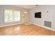 Bright living room with hardwood floors, tan walls, and window with blinds allowing natural light at 2810 Nancy St, Orlando, FL 32806