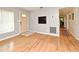 Bright room with hardwood floors, neutral walls and view into a hallway with additional living spaces at 2810 Nancy St, Orlando, FL 32806