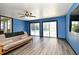 Bright living room featuring wood-look flooring, and sliding glass doors with pool view at 2810 Nancy St, Orlando, FL 32806