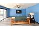 Bright living room with blue walls, wood-look flooring, and sliding glass doors at 2810 Nancy St, Orlando, FL 32806
