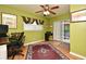 Office space with green walls, hardwood floors, ceiling fan, and sliding glass door to patio at 2810 Nancy St, Orlando, FL 32806