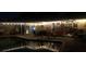 Backyard pool at night with accent lighting around the pool and string lights over the patio and porch areas at 2810 Nancy St, Orlando, FL 32806