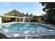 Sparkling pool surrounded by lush landscaping and various buildings at 2810 Nancy St, Orlando, FL 32806