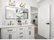Bright bathroom features double vanity, large mirror, and modern finishes at 309 N Kepler Rd, Deland, FL 32724