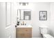 Chic powder room with modern vanity, stylish mirror, and contemporary fixtures at 309 N Kepler Rd, Deland, FL 32724