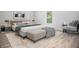 Staged bedroom with modern furnishings, including a platform bed, bench, and stylish decor at 309 N Kepler Rd, Deland, FL 32724