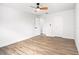 An airy bedroom with light wood flooring, a ceiling fan, and a neutral color scheme at 309 N Kepler Rd, Deland, FL 32724
